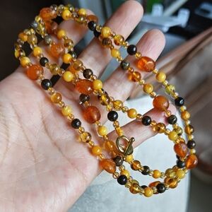 144 Mixed Amber Beads long Necklace, length 85cm.With modern clasp